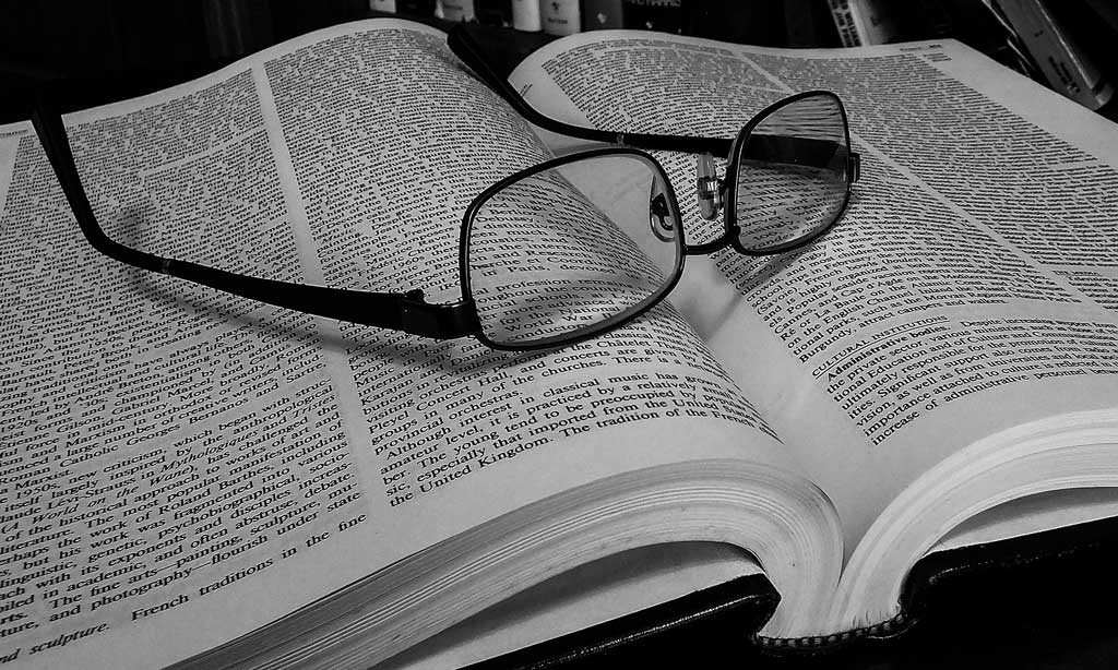 Image of reading glasses on dictionary