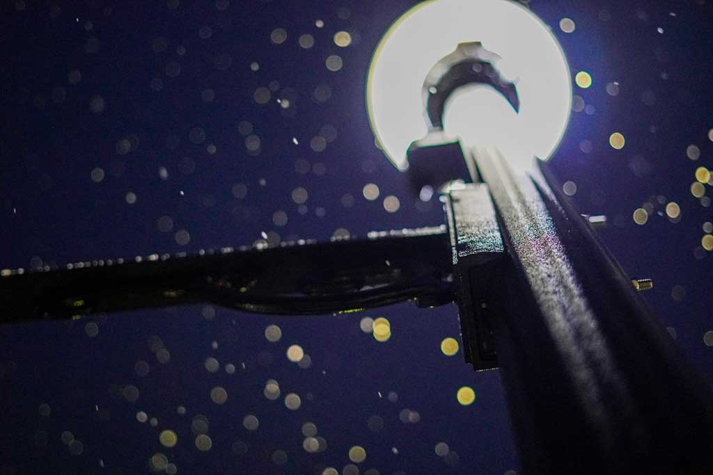 Image of a lamp post at night with snow falling